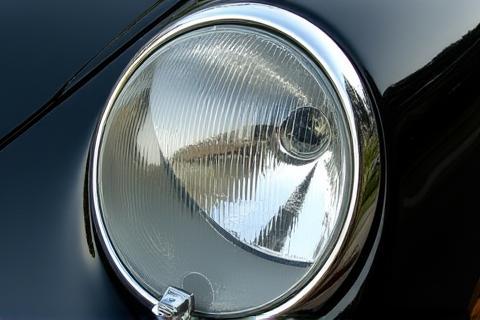 Close-up of a restored, clear car headlight.